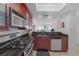 Contemporary kitchen with brown cabinets, stainless steel appliances, and granite countertops, offers modern living at 270 E Flamingo Rd # 106, Las Vegas, NV 89169
