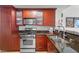 Modern kitchen with stainless steel appliances and brown cabinets offers a practical cooking space at 270 E Flamingo Rd # 106, Las Vegas, NV 89169