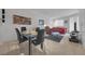 Open-plan living and dining area furnished with modern decor, including a glass-top dining table and sofa at 270 E Flamingo Rd # 106, Las Vegas, NV 89169