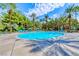Large community pool with palm trees, lounge chairs, and umbrellas, perfect for enjoying the sunny weather at 270 E Flamingo Rd # 106, Las Vegas, NV 89169