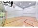 Bright indoor racquetball court with hardwood floors, glass door, and overhead lighting for active recreation at 270 E Flamingo Rd # 106, Las Vegas, NV 89169