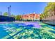 Well-maintained tennis court on a sunny day, surrounded by trees and a multi-story building in the background at 270 E Flamingo Rd # 106, Las Vegas, NV 89169