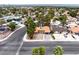 Expansive aerial view of a single-Gathering home with a red tile roof and a refreshing swimming pool in the backyard at 3135 La Mesa Dr, Henderson, NV 89014