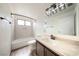 Stylish bathroom featuring modern fixtures, framed mirror, and shower-tub combo at 3135 La Mesa Dr, Henderson, NV 89014