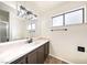 Bright bathroom featuring modern vanity, framed mirror, and decorative lighting at 3135 La Mesa Dr, Henderson, NV 89014