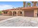 Single-story home with tile roof, desert landscaping, and attached garage on a sunny day at 3135 La Mesa Dr, Henderson, NV 89014