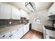 Modern kitchen features updated appliances, grey tile backsplash, and updated countertops at 3135 La Mesa Dr, Henderson, NV 89014