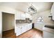Modern kitchen with white cabinets and stainless steel appliances at 3135 La Mesa Dr, Henderson, NV 89014