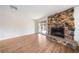 Living room with wood floors and stone fireplace at 3135 La Mesa Dr, Henderson, NV 89014