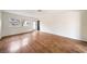 The unfurnished living room has warm wood floors, large windows, and abundant natural light at 3135 La Mesa Dr, Henderson, NV 89014