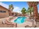 A sparkling swimming pool, lush tropical landscaping, and serene outdoor living define this backyard oasis at 3135 La Mesa Dr, Henderson, NV 89014