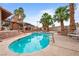 Sparkling pool with mature palms, and ample deck and lounge areas creates a resort-like backyard oasis at 3135 La Mesa Dr, Henderson, NV 89014
