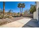 The backyard features a rock garden, some drought resistant plants and a concrete patio at 3141 Diamond Crest Ln, Henderson, NV 89052