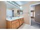 Bathroom featuring dual sinks with a large mirror and lots of vanity storage at 3141 Diamond Crest Ln, Henderson, NV 89052