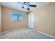 Bedroom with beige walls, plush carpet, and a window with blinds, offers a cozy feel at 3141 Diamond Crest Ln, Henderson, NV 89052
