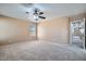 Bedroom featuring neutral carpet, ceiling fan, and a hallway to other bedrooms at 3141 Diamond Crest Ln, Henderson, NV 89052