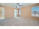 Light-filled bedroom with neutral carpet, ceiling fan, and an attached walk-in closet at 3141 Diamond Crest Ln, Henderson, NV 89052