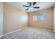 Neutral bedroom features a ceiling fan, plush carpet, and bright window at 3141 Diamond Crest Ln, Henderson, NV 89052