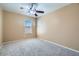 Bedroom featuring neutral carpet, a ceiling fan and views of the backyard at 3141 Diamond Crest Ln, Henderson, NV 89052