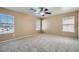 Bright bedroom showcasing neutral carpet, a ceiling fan and lots of bright windows at 3141 Diamond Crest Ln, Henderson, NV 89052