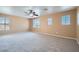 Large bedroom featuring neutral carpet, a ceiling fan and many bright windows at 3141 Diamond Crest Ln, Henderson, NV 89052