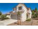 Two story home features a desert landscape, tile roof, and a two car garage at 3141 Diamond Crest Ln, Henderson, NV 89052