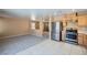 Well lit kitchen offers stainless steel appliances and wood cabinets at 3141 Diamond Crest Ln, Henderson, NV 89052