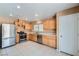 Well lit kitchen offers stainless steel appliances and wood cabinets at 3141 Diamond Crest Ln, Henderson, NV 89052