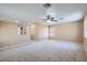 Spacious living room with plush carpet, neutral color palette, and bright natural light at 3141 Diamond Crest Ln, Henderson, NV 89052