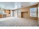 Neutral living room features carpet, kitchen access, and windows with blinds at 3141 Diamond Crest Ln, Henderson, NV 89052