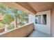 Private outdoor balcony area with stucco walls and railing and view of mature tree at 3151 Soaring Gulls Dr # 2050, Las Vegas, NV 89128
