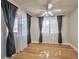 Bedroom featuring wood flooring, ceiling fan, and multiple windows at 3151 Soaring Gulls Dr # 2050, Las Vegas, NV 89128