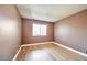 Neutral bedroom featuring modern flooring and a large, bright window at 3151 Soaring Gulls Dr # 2050, Las Vegas, NV 89128