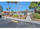 Community clubhouse exterior featuring accessible ramps, mature trees, and sidewalks at 3151 Soaring Gulls Dr # 2050, Las Vegas, NV 89128