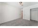 Cozy bedroom features neutral carpet, white walls, a modern light fixture and closet with shelving at 3463 Haverford Ave, Las Vegas, NV 89121