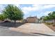 Attractive single-story home boasts a lush front yard with mature trees and a wide driveway at 3463 Haverford Ave, Las Vegas, NV 89121