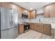 Modern kitchen with stainless steel appliances, light wood cabinets, and stylish backsplash at 3463 Haverford Ave, Las Vegas, NV 89121