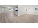 Open-concept living and dining area showcasing modern lighting and wood-look flooring at 3463 Haverford Ave, Las Vegas, NV 89121