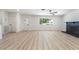 Bright and airy living area with a fireplace, white walls, and decorative front door at 3463 Haverford Ave, Las Vegas, NV 89121