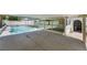 A covered patio area provides a shaded view of the sparkling pool and landscaped backyard of this home at 3463 Haverford Ave, Las Vegas, NV 89121