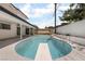 Sparkling pool with diving board surrounded by patio, landscaping and fencing for privacy at 3463 Haverford Ave, Las Vegas, NV 89121