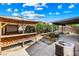 Backyard features a gazebo, covered patio and concrete, surrounded by landscaping at 371 Cambray St, Henderson, NV 89074