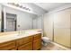 Bathroom featuring a sliding glass door shower, single vanity, and mirrored wall at 371 Cambray St, Henderson, NV 89074