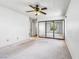 Spacious bedroom with a mirrored closet, ceiling fan, and windows overlooking the backyard at 371 Cambray St, Henderson, NV 89074