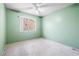 Bedroom features an window overlooking the back and green painted walls at 371 Cambray St, Henderson, NV 89074