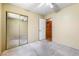 Bedroom featuring a ceiling fan and mirrored closet doors at 371 Cambray St, Henderson, NV 89074