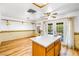 Bright dining area with hardwood floors, ceiling fan, and view to the backyard at 371 Cambray St, Henderson, NV 89074