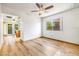 Bright dining area with a ceiling fan, hardwood floors, and sliding glass doors to the backyard at 371 Cambray St, Henderson, NV 89074