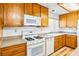 Charming kitchen with wood cabinets, white appliances and gas range at 371 Cambray St, Henderson, NV 89074
