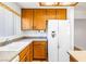 Cozy kitchen featuring wood cabinets, light countertops, and a white refrigerator at 371 Cambray St, Henderson, NV 89074